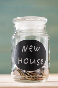 jar with coins to save downpayment for new house